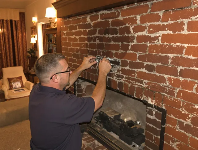 Wilmington Island Chimney Sweep expert fixing a fireplace in Wilmington Island, GA